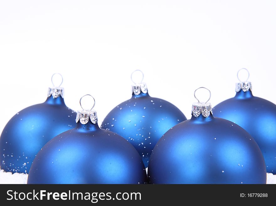 Blue matt christmas balls on snow in close up. Blue matt christmas balls on snow in close up