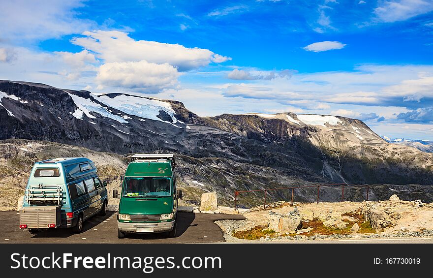 Camper vans on roadside parking area at Dalsnibba viewpoint, norwegian mountains landscape. Traveling, holidays and adventure concept. Camper vans on roadside parking area at Dalsnibba viewpoint, norwegian mountains landscape. Traveling, holidays and adventure concept
