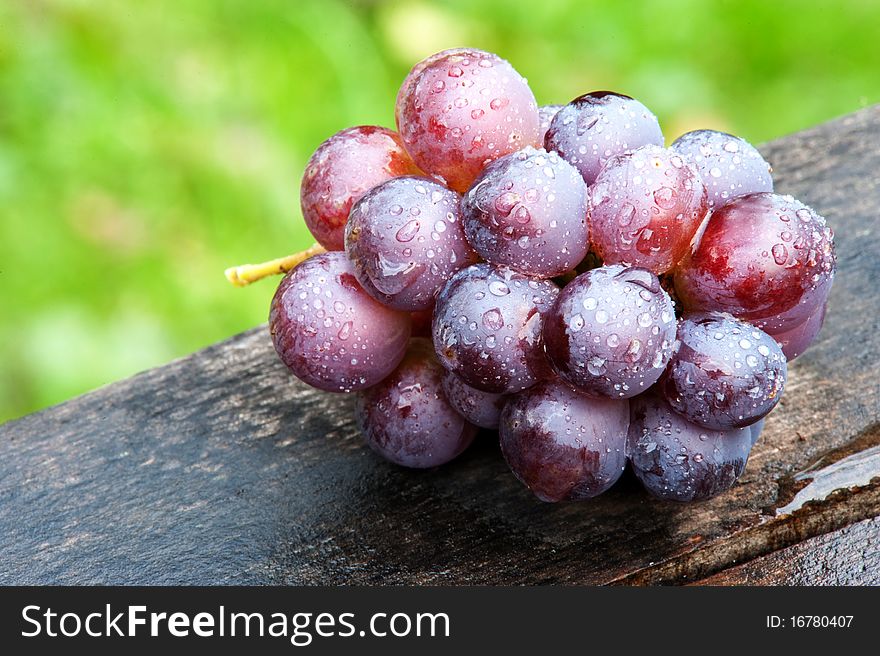 Wet grapes on an old wooden table. Wet grapes on an old wooden table