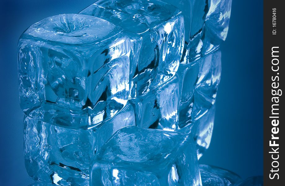 Frozen ice cubes on blue background