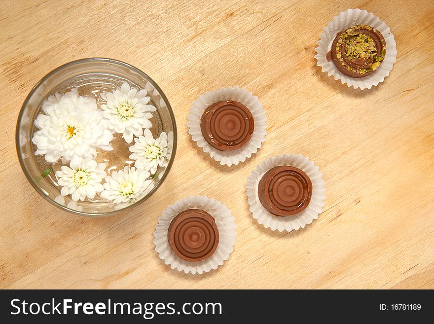 Homemade sweet chocolate with white flowers on the wooden table