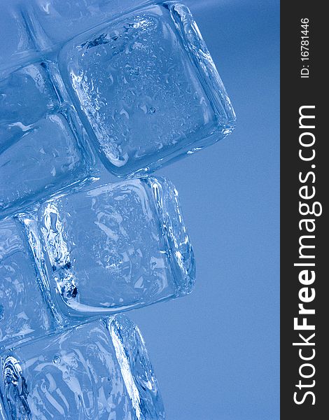 Frozen ice cubes on blue background