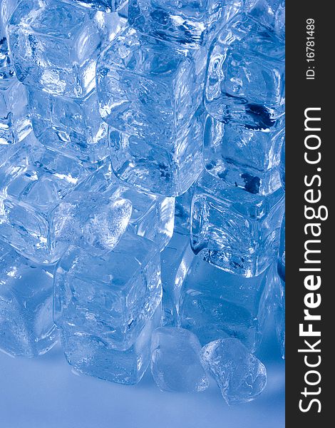 Frozen ice cubes on blue background. Frozen ice cubes on blue background