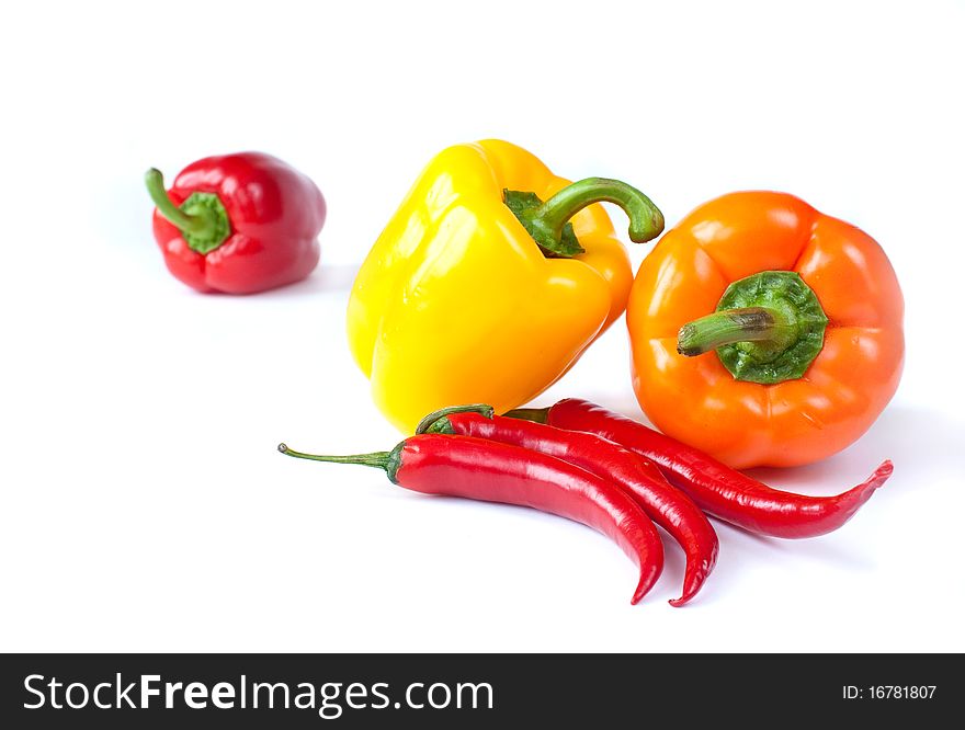 Three colored peppers on a white background. Three colored peppers on a white background
