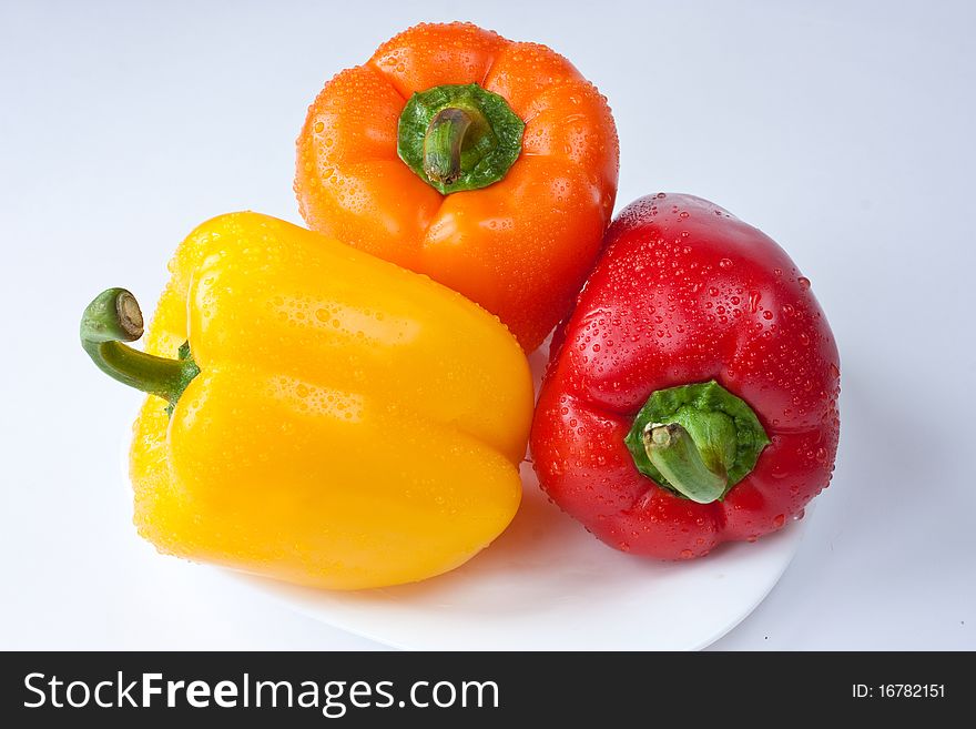 Three colored peppers on a white background. Three colored peppers on a white background