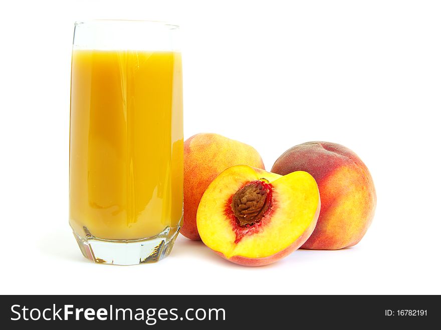 Glass with freshly made peach juice on a white background