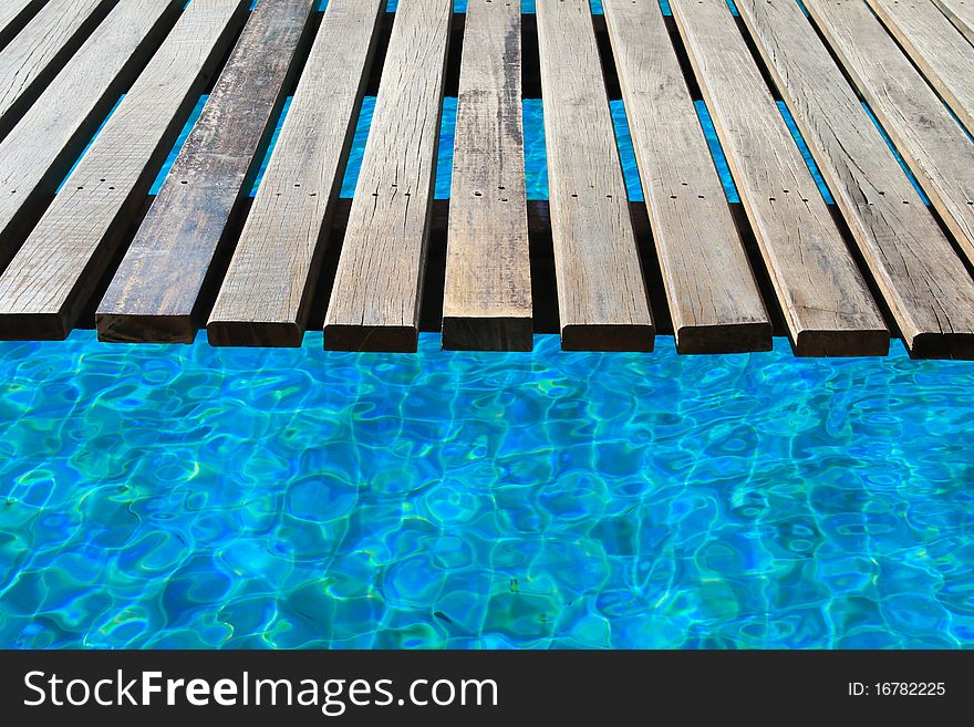 The wooden bridge in a swimming pool. The wooden bridge in a swimming pool