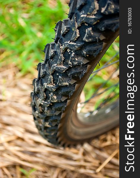 Dirty bike wheel on the ground, closeup