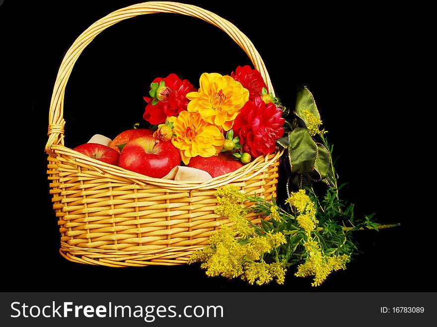 Autumn Basket with red apples and flowers isolated on the black background. Autumn Basket with red apples and flowers isolated on the black background.