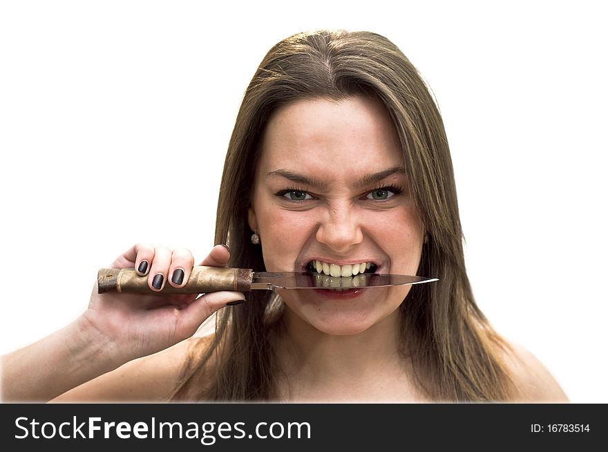 Young woman with green eyes holding a knife in his teeth. Studio shot on white background. Young woman with green eyes holding a knife in his teeth. Studio shot on white background.