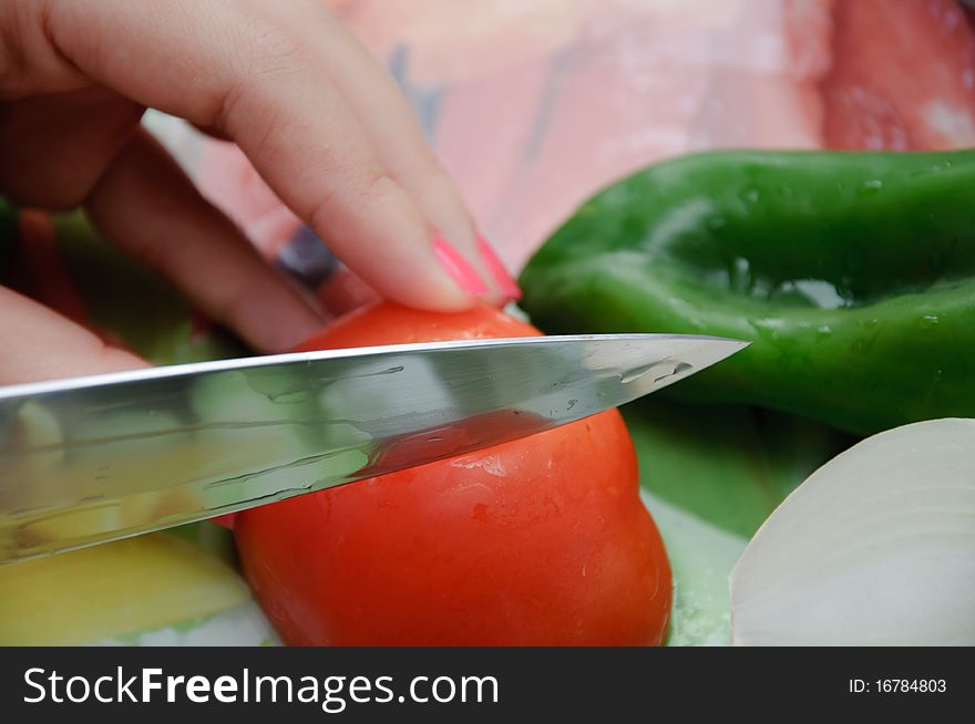 Fresh vegetables on a cut table. Tomato, onion and pepper