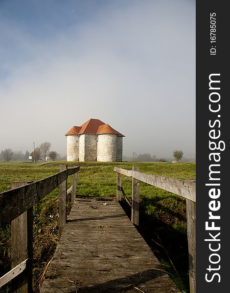 Medieval castle wrapped in a morning fog