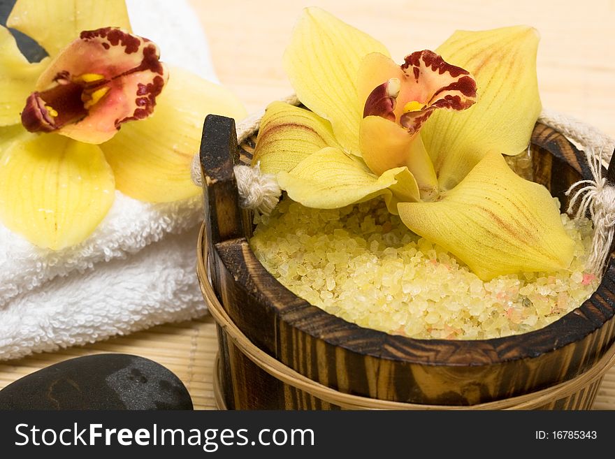 Spa essentials (salt for bath, white towel and orchids)