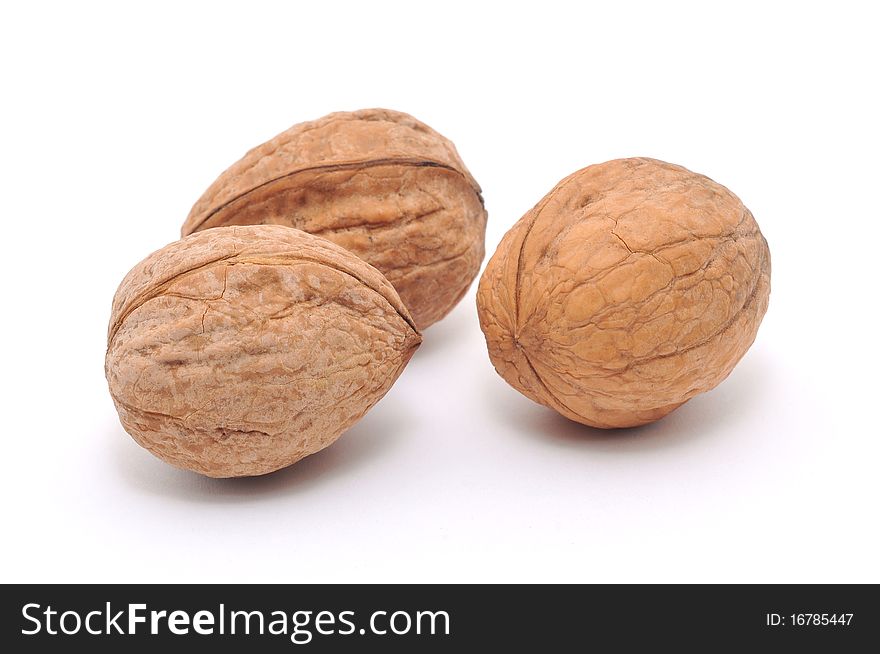 Isolated walnuts. Three isolated walnuts.