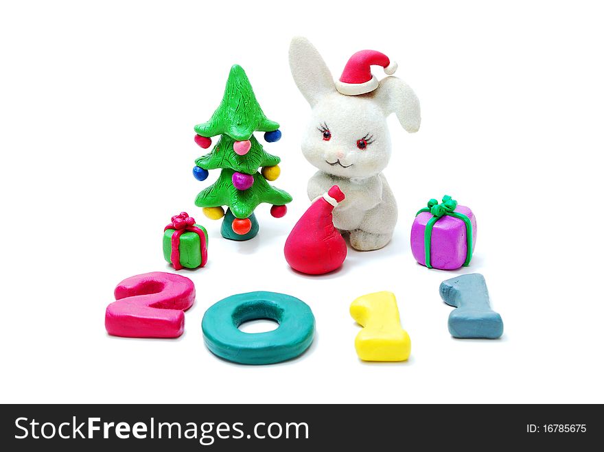 3D New Year Text 2011 Made of Colored Plasticine with Rabbit, Gifts and Christmas Tree Isolated on White Background. 3D New Year Text 2011 Made of Colored Plasticine with Rabbit, Gifts and Christmas Tree Isolated on White Background