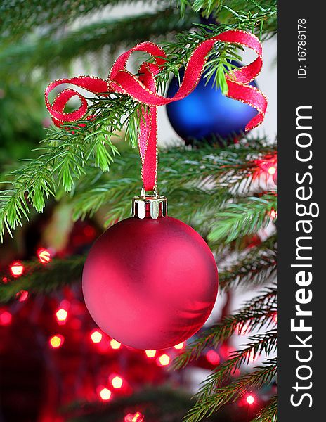 Xmas decoration tied with ribbon hanging from evergreen branch. Xmas decoration tied with ribbon hanging from evergreen branch
