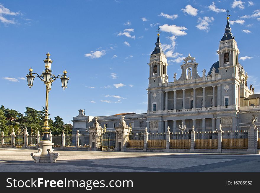 The Nuestra Senora de La Almudena Cathedral facade in Madrid and a golden lamp of the Madrid Royal Palace