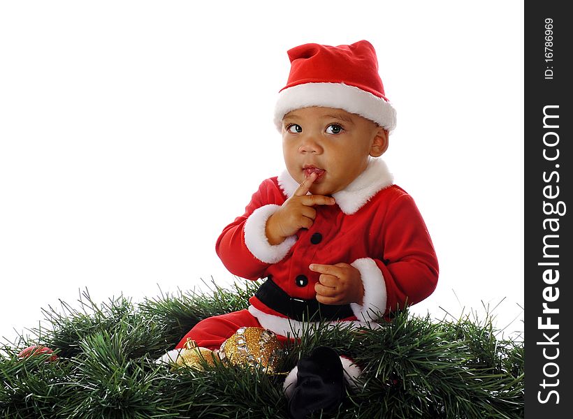 A cautious biracial Santa holding a finger to his lips. Isolated on white. A cautious biracial Santa holding a finger to his lips. Isolated on white.