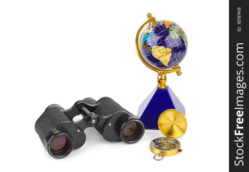 Binoculars, compass and globe - travel concept
