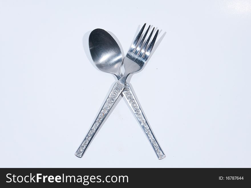 Spoon and fork on a white background. Utensils used for dessert.