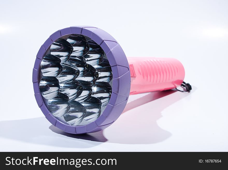 Flashlight on white background. Placed on a colorful background. The dark night for two.