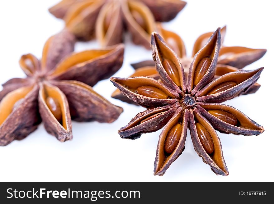 An assortment of star anise seeds on white studio background