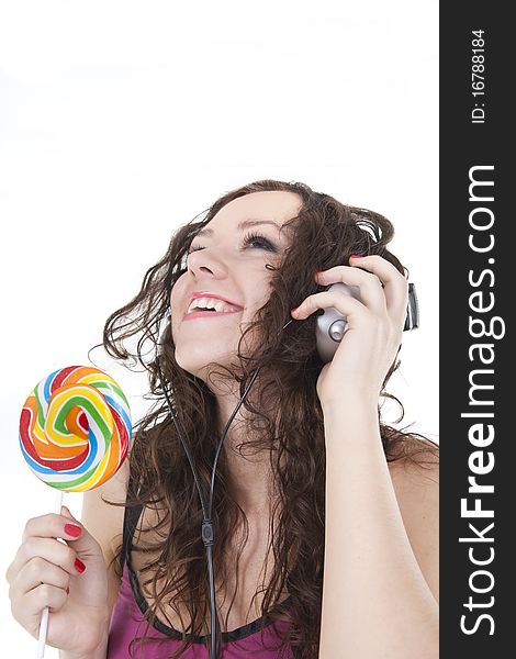 Girl listening music and have a lollipop