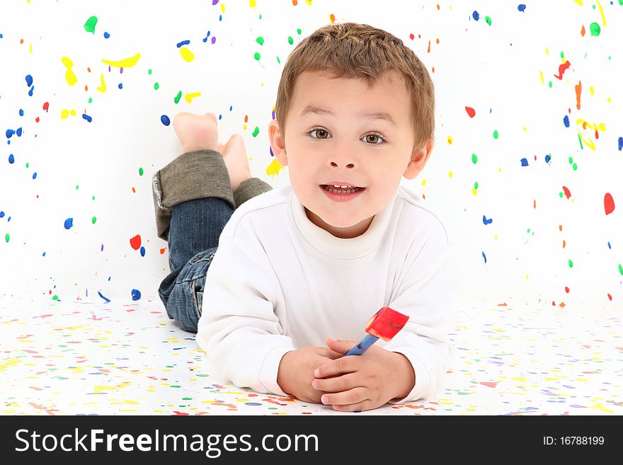 Adorable two year old toddler boy over paint splatter background in casual. Adorable two year old toddler boy over paint splatter background in casual.