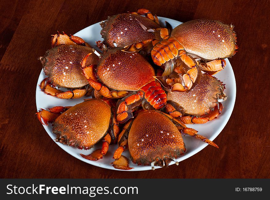 Pile of crabs on a plate ready to cook.