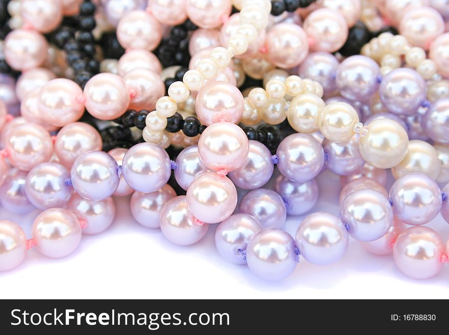 Colorful necklaces on white background.