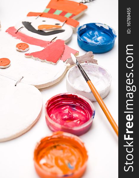 Wooden snowman painted by child with color paints in covers. Wooden snowman painted by child with color paints in covers