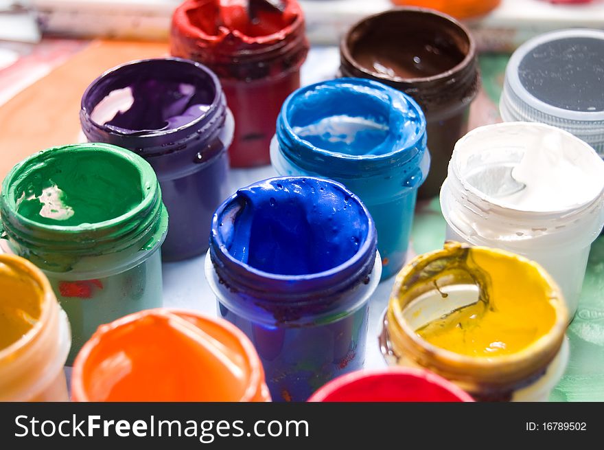 Closeup of open buckets with color paints, view from above. Closeup of open buckets with color paints, view from above