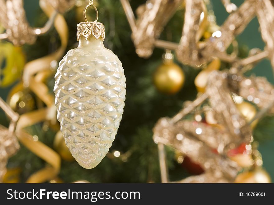 Holiday series: christmas cone decoration on decorated fir background. Holiday series: christmas cone decoration on decorated fir background