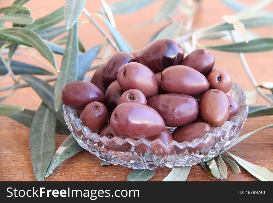 Black Olives and on a wooden table