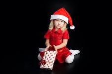 Surprised Girl In Santa Cap With Gift Stock Photo