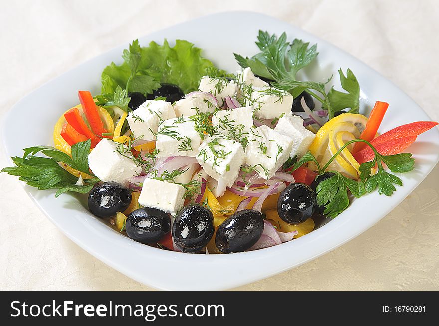 Slices of cheese in a salad of feta cheese and diced vegetables