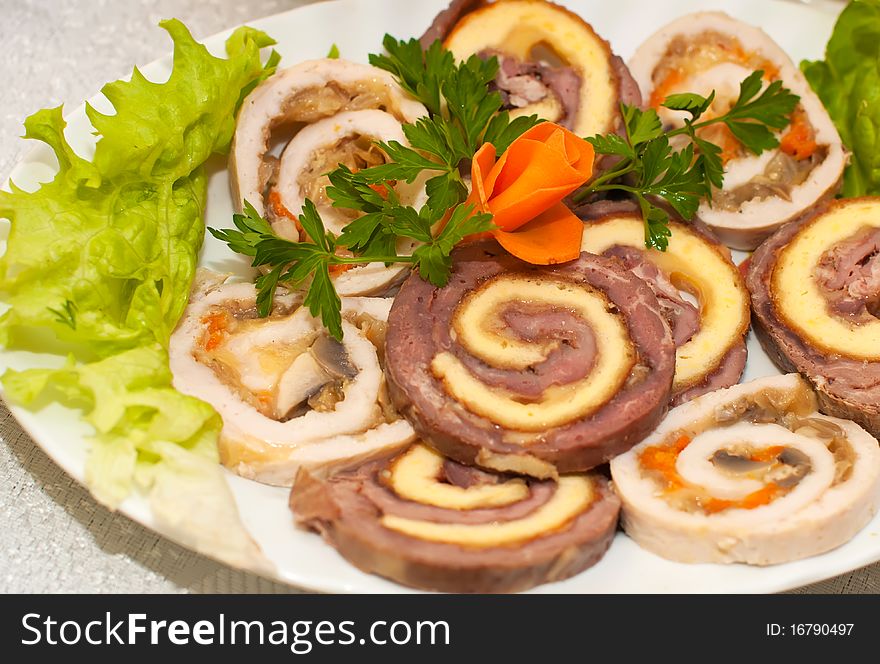 Croped roll with meat and mushrooms on the white plate