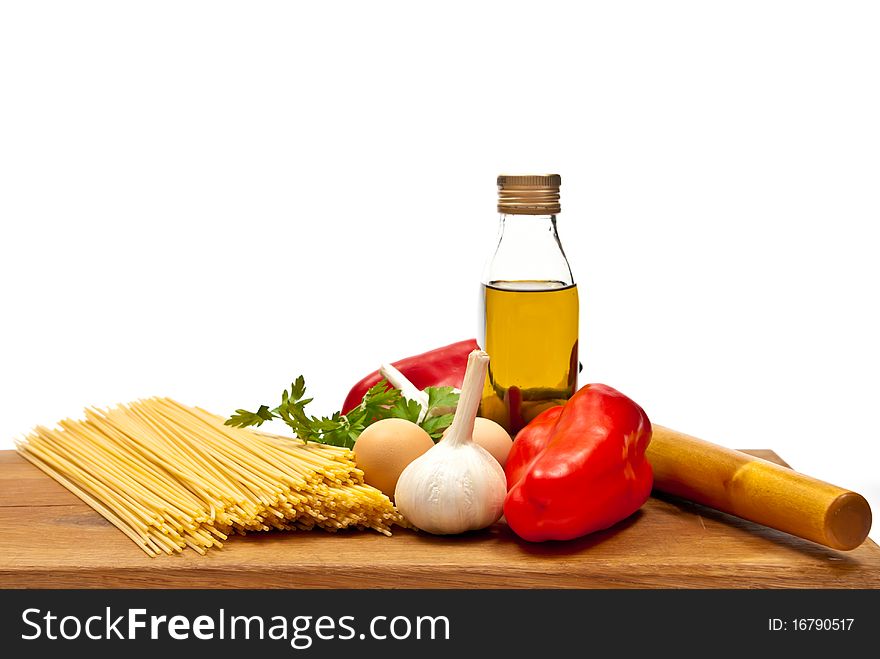 Close-up shot of spaghetti and vegetables on wooden board. Studio shot