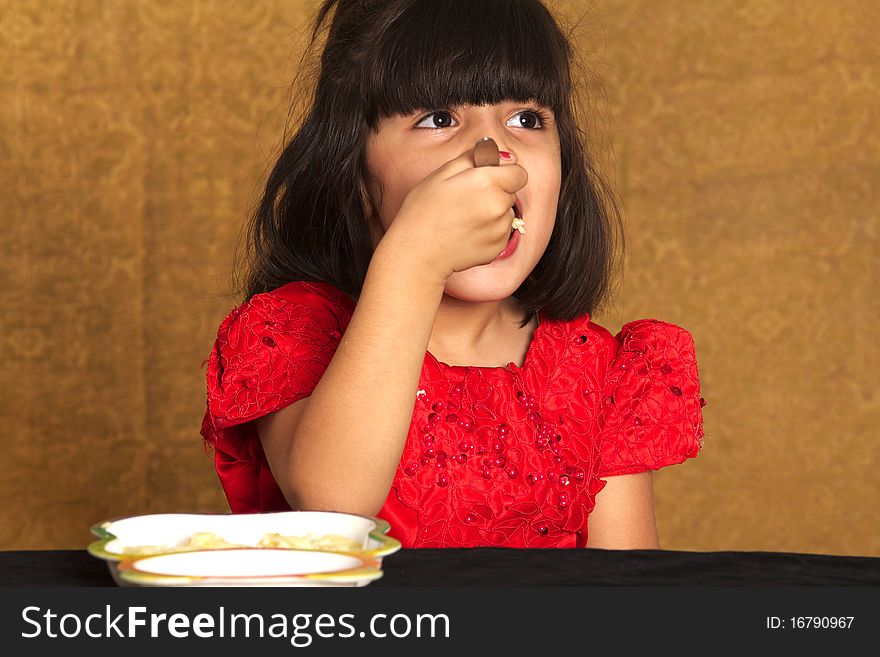 Beautiful Little girl eating spaghetti