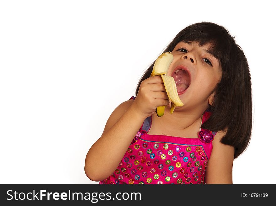 Portrait of a sweet young girl eating banana isolated on white background