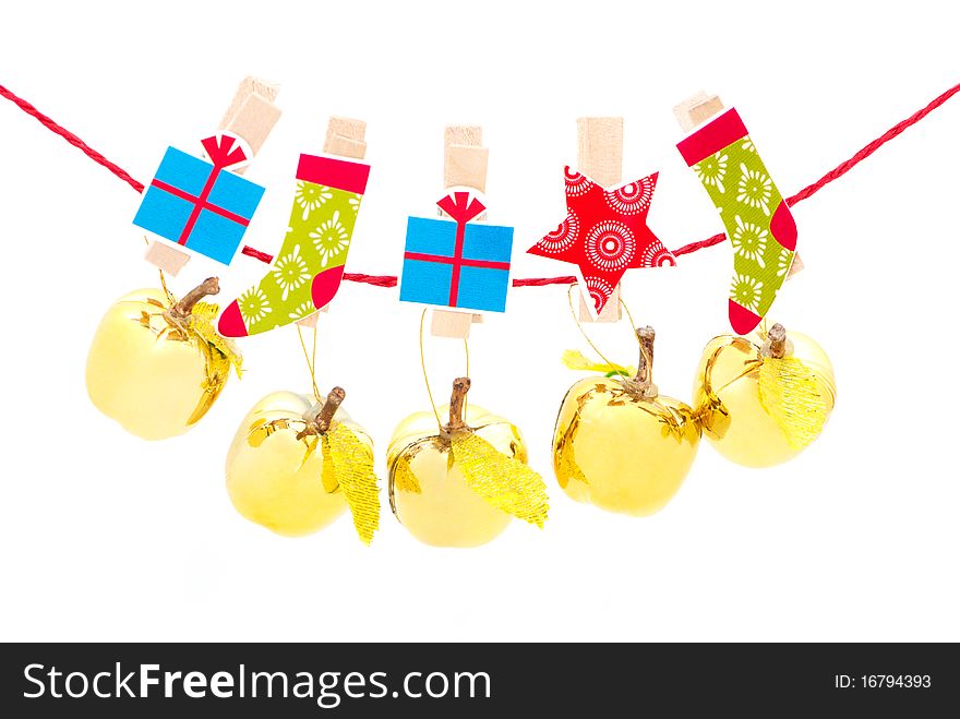 Christmas decorations - golden apples hanging in a row