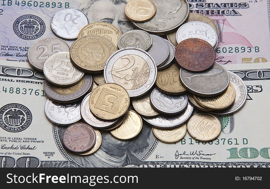 Coins of different countries lie on the dollar. Coins of different countries lie on the dollar