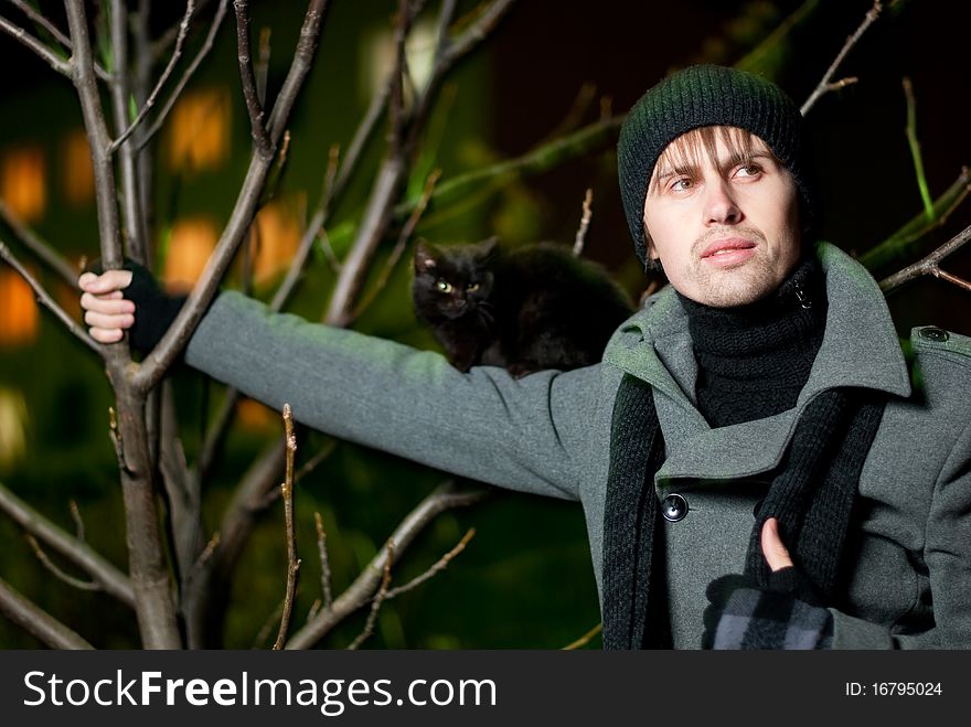 Young man with black cat on his shoulder. Young man with black cat on his shoulder