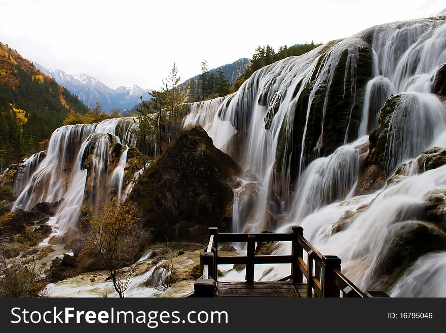 Beautiful waterfall in forest in autumn