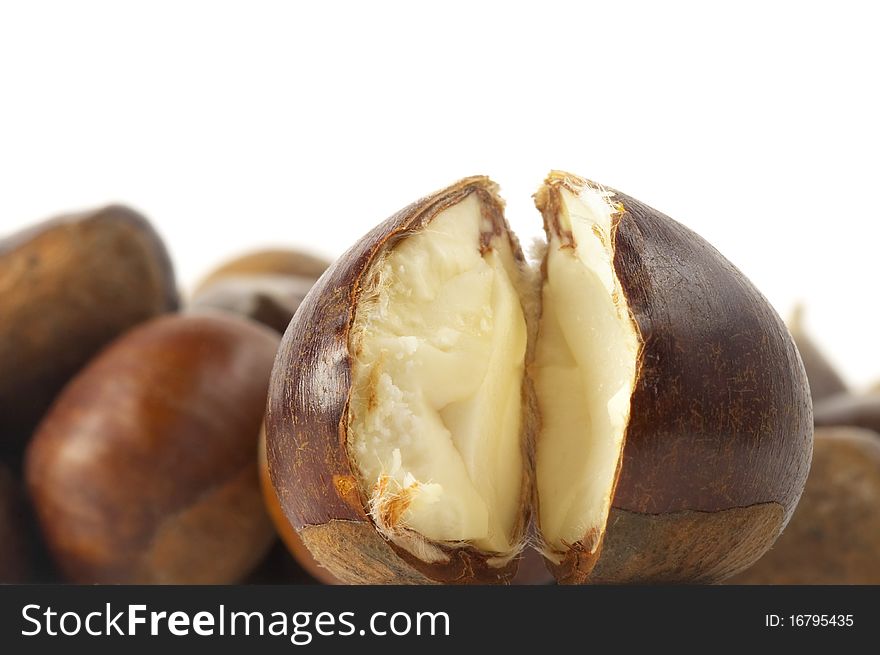 Heap of chestnuts with one cracked on over white background. Heap of chestnuts with one cracked on over white background