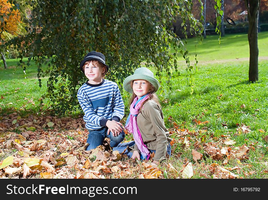 Portrait of Happy girl and boy enjoying golden autumn fall season. Portrait of Happy girl and boy enjoying golden autumn fall season