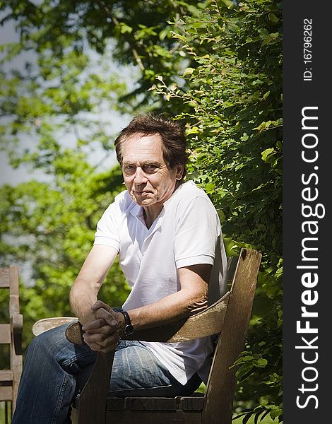 Portrait of an elderly man sitting in the park. Portrait of an elderly man sitting in the park