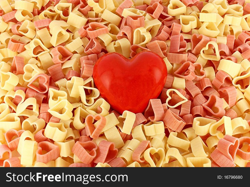 Colored pasta in form of heart with big red heart. Colored pasta in form of heart with big red heart