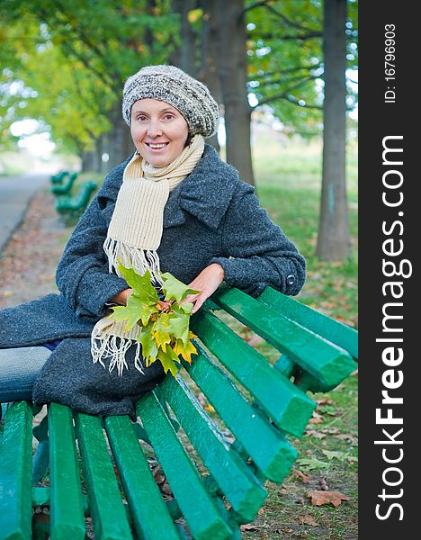 Pretty young woman resting on a bench