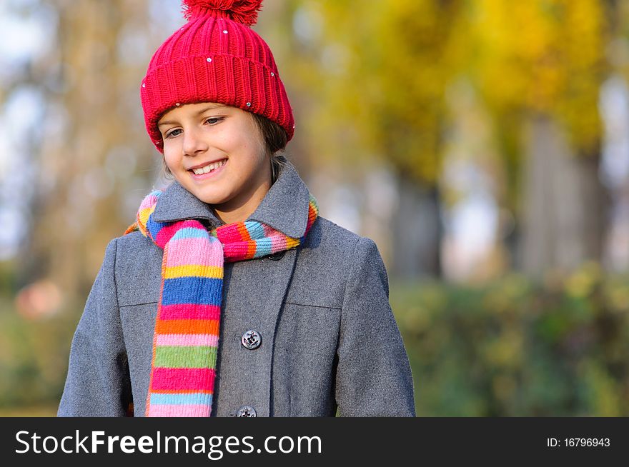 Little Miss. Pretty cute girl walks in autumn park